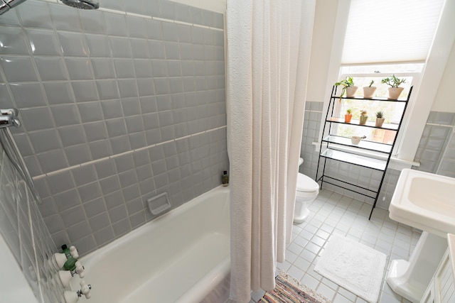 bathroom with tile walls, shower / tub combo, tile patterned floors, and toilet