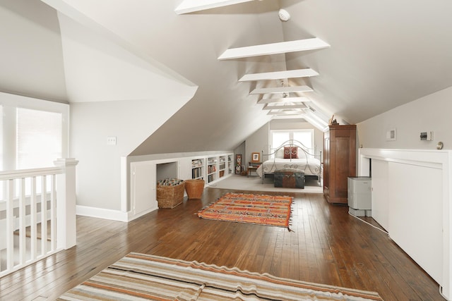 bedroom with dark wood-type flooring and vaulted ceiling