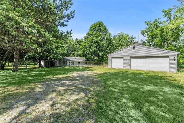 7888 Mingo Lewisburg Rd, North Lewisburg, OH 43060 - view of green lawn featuring a detached garage and an outdoor structure