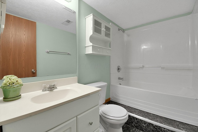 full bathroom featuring vanity, a textured ceiling, toilet, and washtub / shower combination