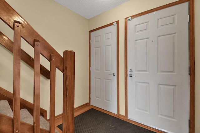 entryway featuring a textured ceiling