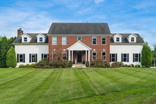 colonial-style house with a front yard