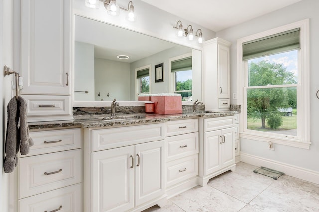 bathroom with tile patterned flooring and vanity