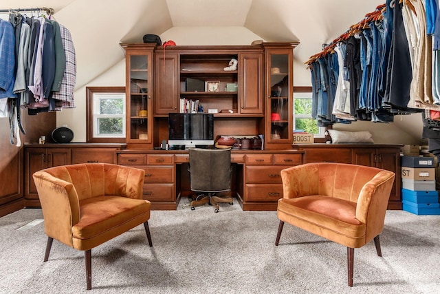 carpeted home office featuring lofted ceiling