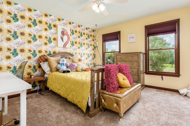 bedroom featuring ceiling fan, carpet floors, and multiple windows