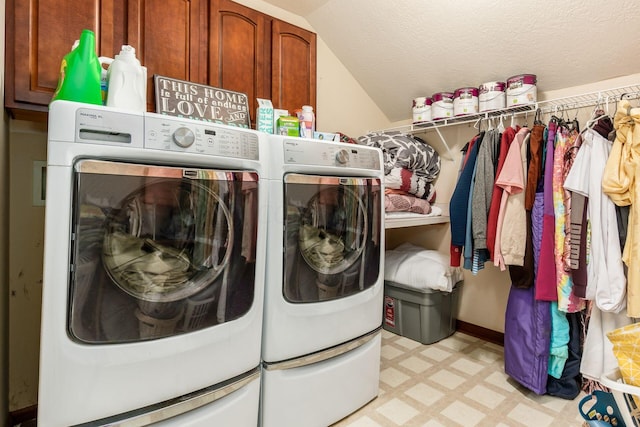 clothes washing area featuring cabinets, independent washer and dryer, and a textured ceiling