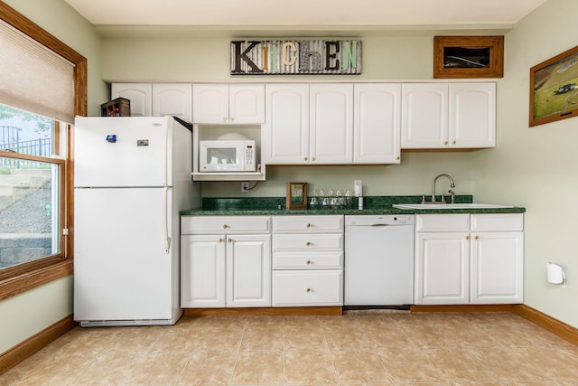 kitchen with light tile patterned floors, white appliances, white cabinetry, and sink