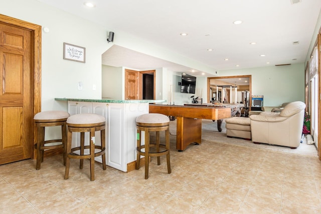 bar with white cabinets and light tile patterned flooring