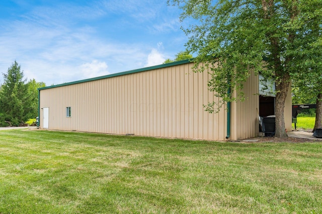 view of property exterior with a yard and an outdoor structure