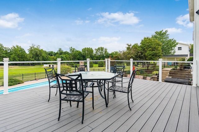 wooden terrace featuring a fenced in pool