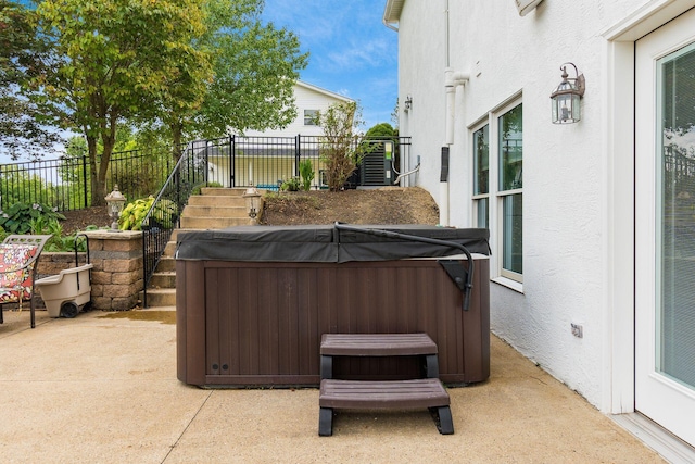 view of patio featuring central AC and a hot tub