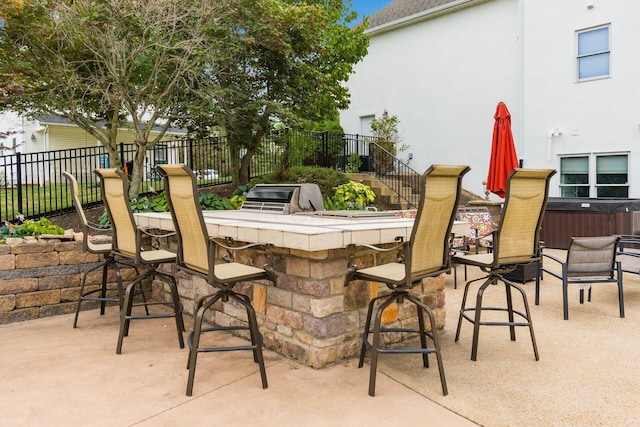 view of patio featuring a bar and exterior kitchen