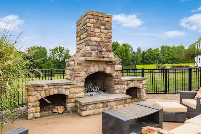 view of patio / terrace with an outdoor stone fireplace and a trampoline