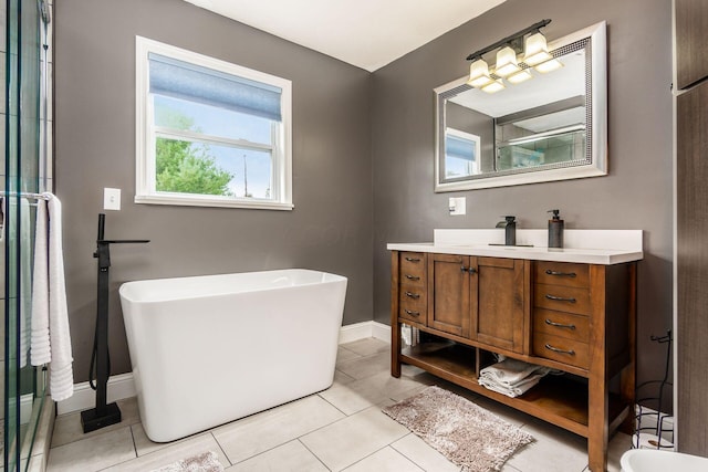 bathroom featuring tile patterned floors, vanity, and a tub