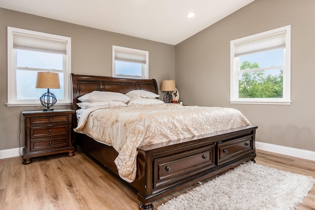 bedroom with light hardwood / wood-style flooring and multiple windows