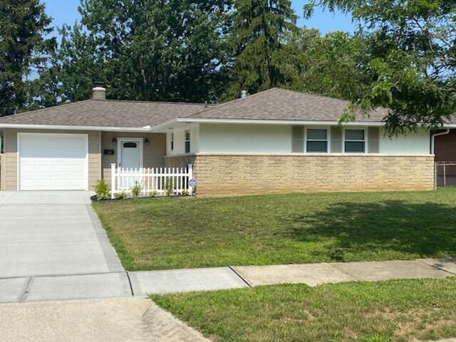 single story home with a garage and a front lawn