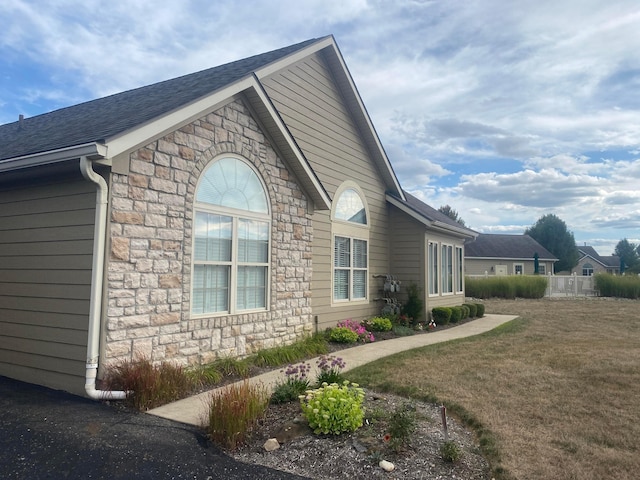 view of property exterior featuring a lawn