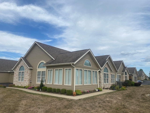 view of home's exterior with central air condition unit and a yard