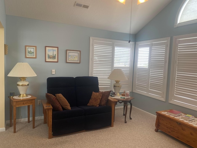 living area with light carpet and lofted ceiling