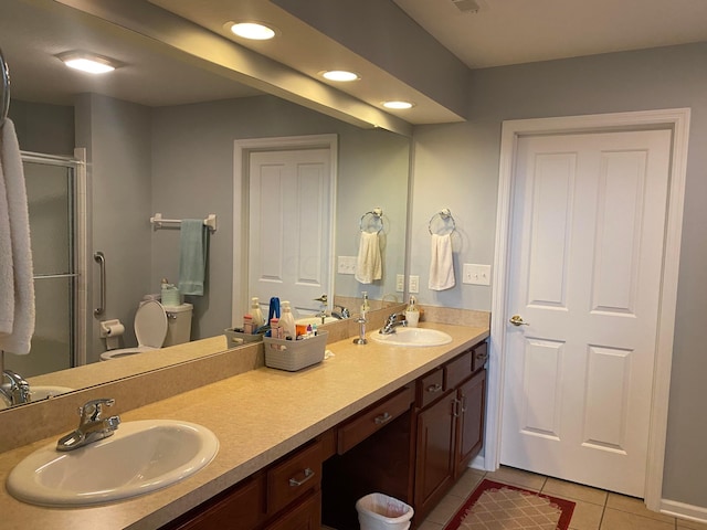 bathroom featuring tile patterned floors, toilet, vanity, and walk in shower