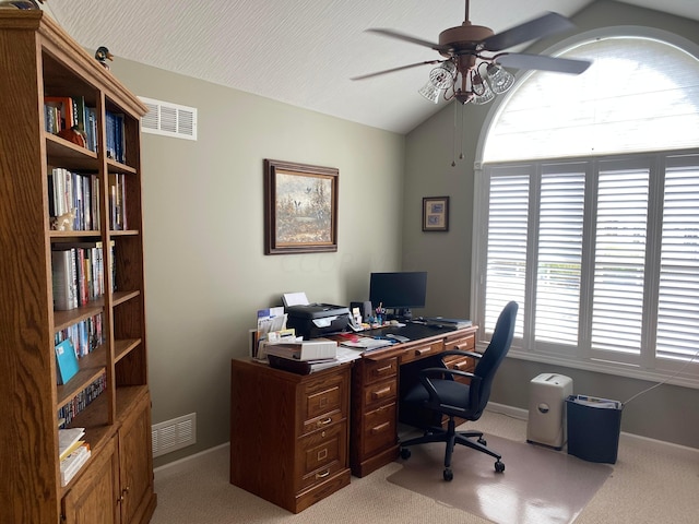 carpeted office with ceiling fan and vaulted ceiling