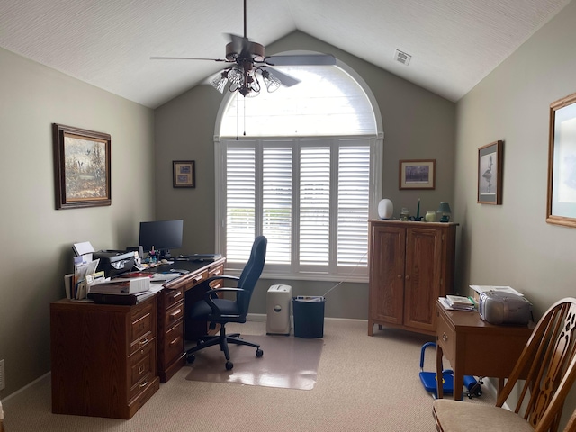 carpeted office space with ceiling fan, a healthy amount of sunlight, lofted ceiling, and a textured ceiling