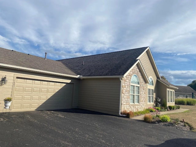 view of side of home featuring a garage