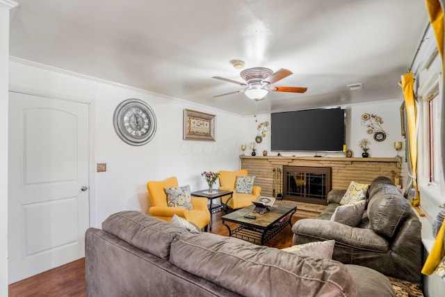 living room featuring dark hardwood / wood-style floors, ceiling fan, and ornamental molding