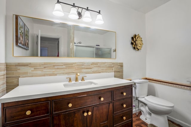 bathroom featuring walk in shower, vanity, and toilet