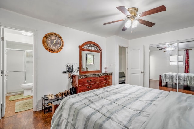 bedroom with ceiling fan, ensuite bath, dark wood-type flooring, and a closet