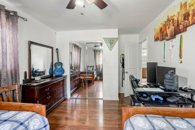 bedroom with ceiling fan, dark hardwood / wood-style floors, and a closet