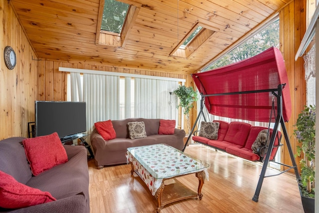 living room with wood walls, plenty of natural light, light hardwood / wood-style floors, and wood ceiling