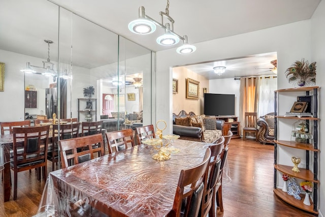 dining area with hardwood / wood-style flooring and ceiling fan