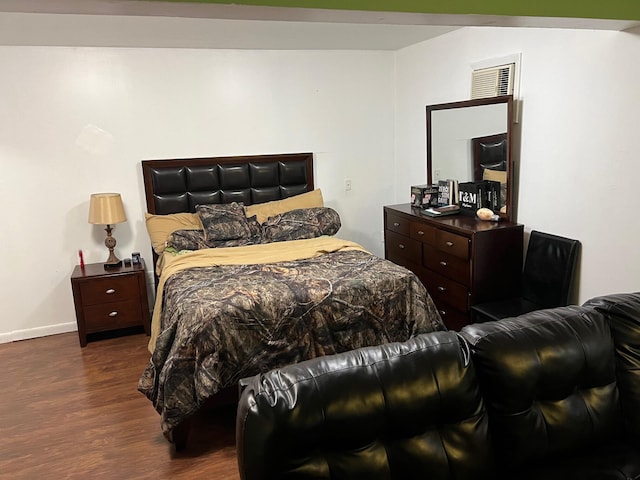 bedroom with dark hardwood / wood-style flooring