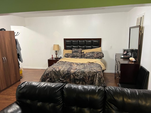 bedroom with dark wood-type flooring