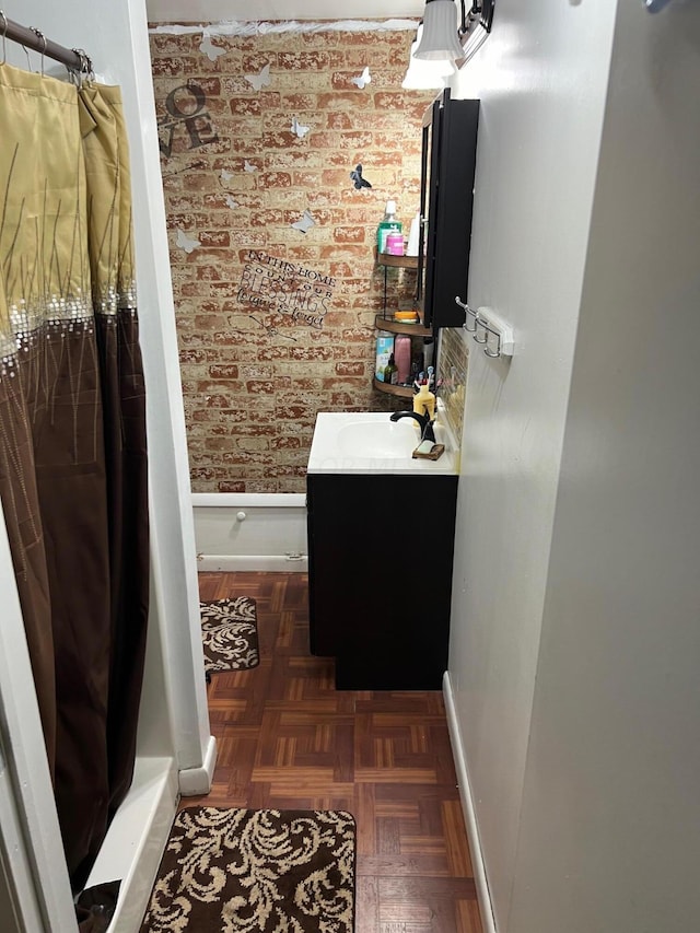 bathroom with a shower with curtain, vanity, and parquet flooring