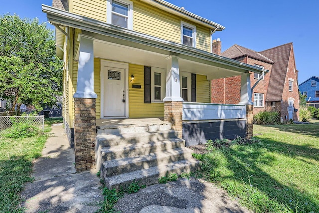 view of front of home with a front lawn and covered porch
