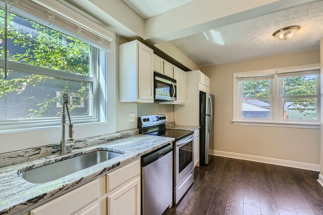 75 N Huron Ave, Columbus, OH 43204 - kitchen featuring stainless steel appliances, dark wood finished floors, white cabinetry, and light stone countertops