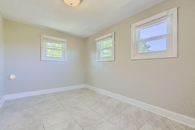 spare room featuring a textured ceiling