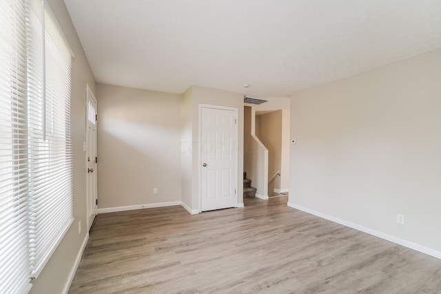 spare room with light hardwood / wood-style flooring