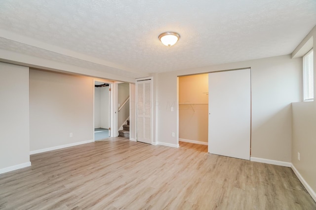 interior space with a textured ceiling and light wood-type flooring