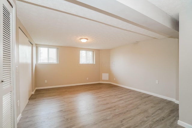 unfurnished bedroom with wood-type flooring and a textured ceiling