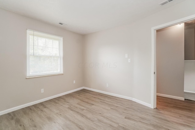 empty room with light hardwood / wood-style floors