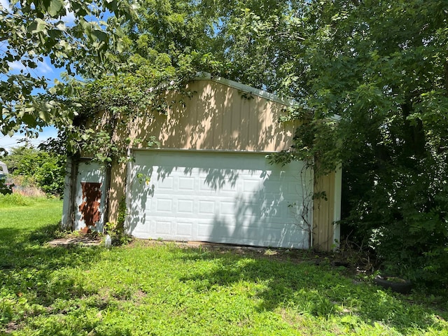 garage featuring a lawn