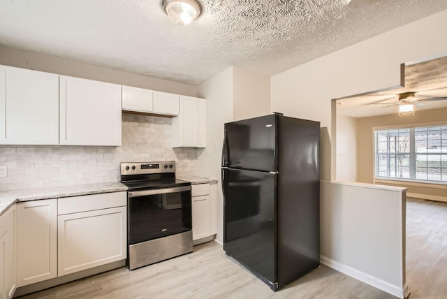 kitchen with electric range, black fridge, white cabinetry, and light hardwood / wood-style flooring