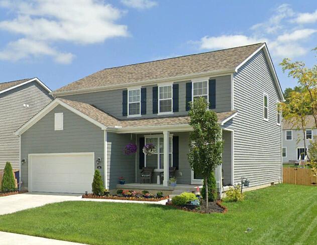 view of front facade with a porch, a garage, and a front lawn