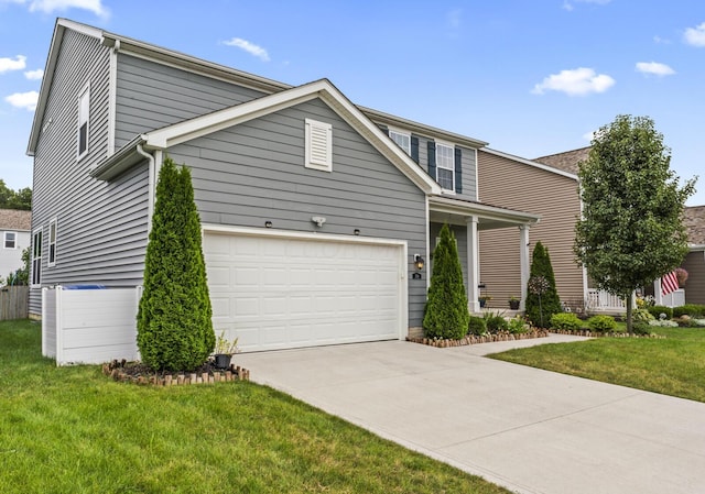 view of property featuring a garage and a front lawn