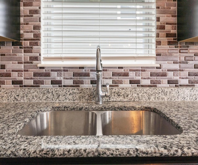 interior details with stone countertops and sink