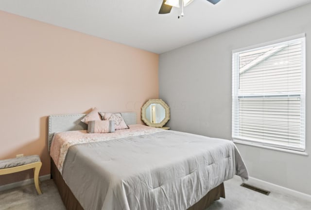 bedroom with ceiling fan and light carpet