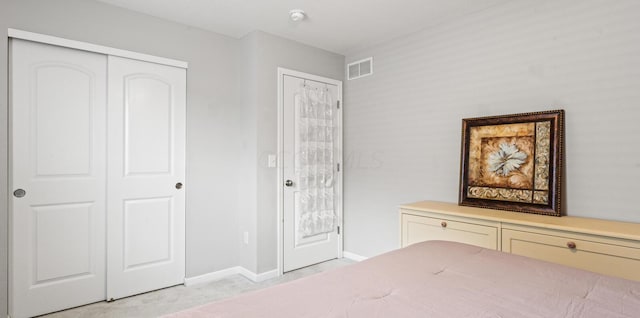 unfurnished bedroom with light carpet and a closet